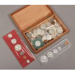 A box of American and Canadian coins, coin sets and bank notes.