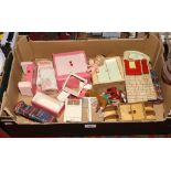 A box of wooden dolls house furniture.