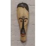 A decorative carved and painted wooden African tribal mask.