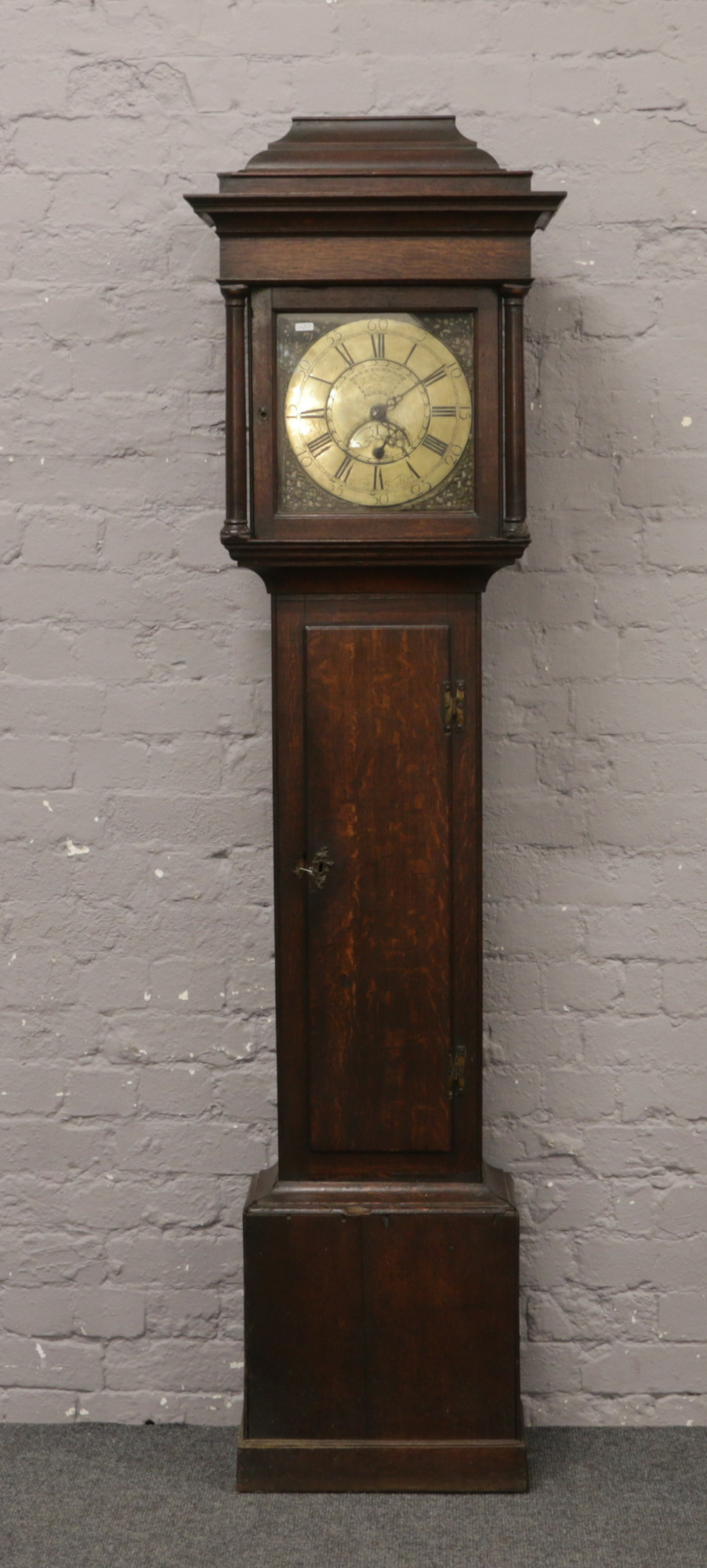 A Georgian oak 30 hour longcase clock with brass dial signed John Woodall / Willis Harthill with