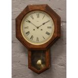 A German Rapport drop dial wall clock with Roman numeral markers with pendulum and key.