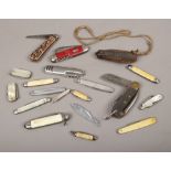 A collection of pen knives and multi tools to include antler and mother of pearl handled examples.