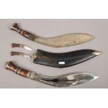 Two Kukri knives one in sheath.