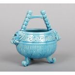 A Burmantofts Faience small planter formed as a cauldron. With twin satyr mask handles, incised