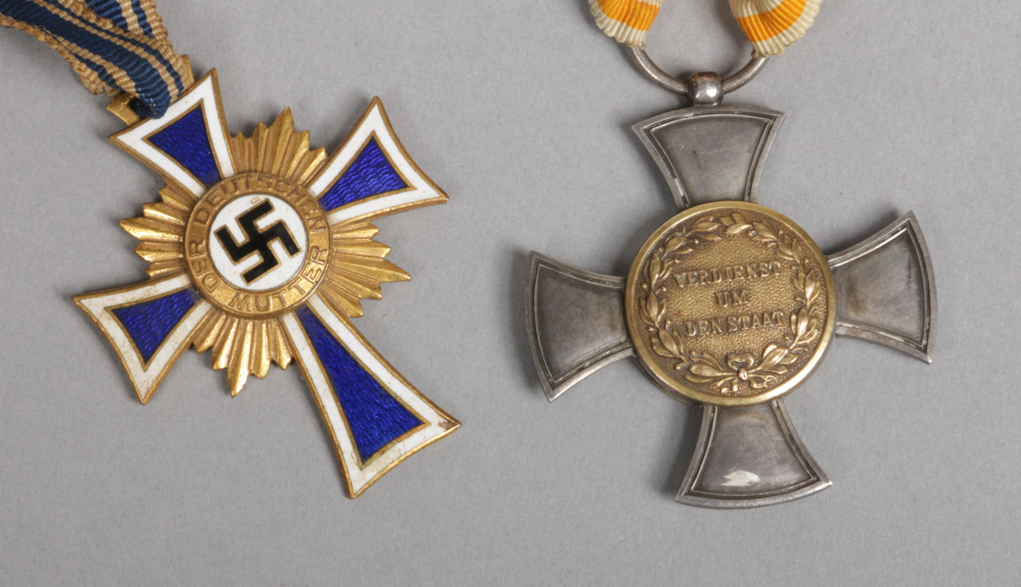 A World War II German Third Reich mothers cross first class in gold along with an Imperial German