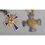 A World War II German Third Reich mothers cross first class in gold along with an Imperial German