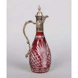 An early 20th century cut and ruby flash claret jug with silver plated mounts, 34cm.