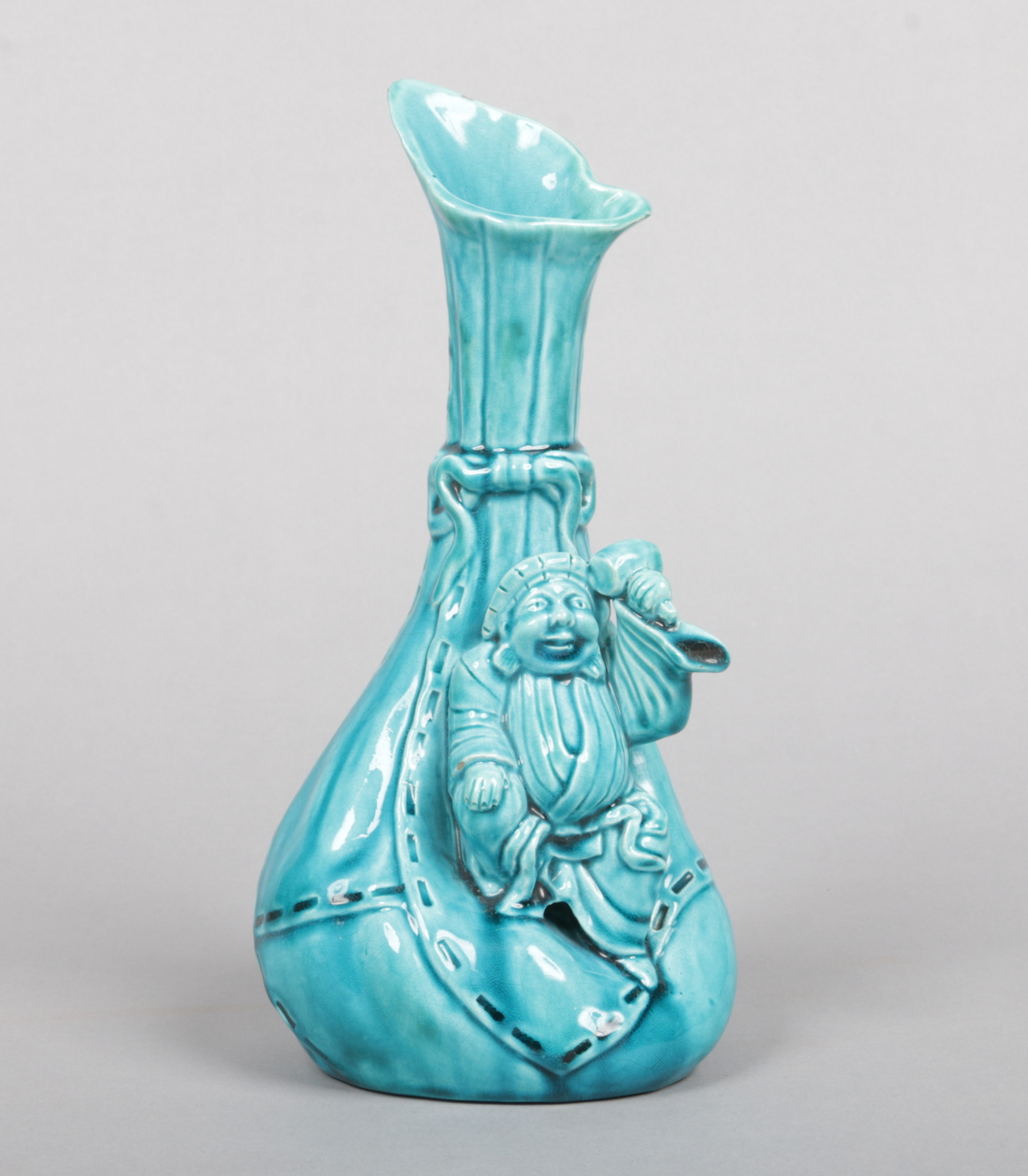 A Burmantofts Faience vase designed by Joseph Walmsley. Modelled as a small Chinese worker resting