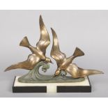 An Art Deco spelter group, pair of seagulls each raised on a scrolling wave and supported on an