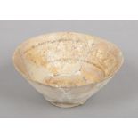 An antique Persian terracotta bowl with glazed decoration, 19cm diameter.