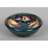 A William Moorcroft bowl decorated in the leaves and berries design. Signed and impressed marks