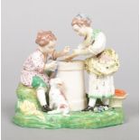 A Derby figure group modelled as two children playing hazard after a painting by Francois Boucher.