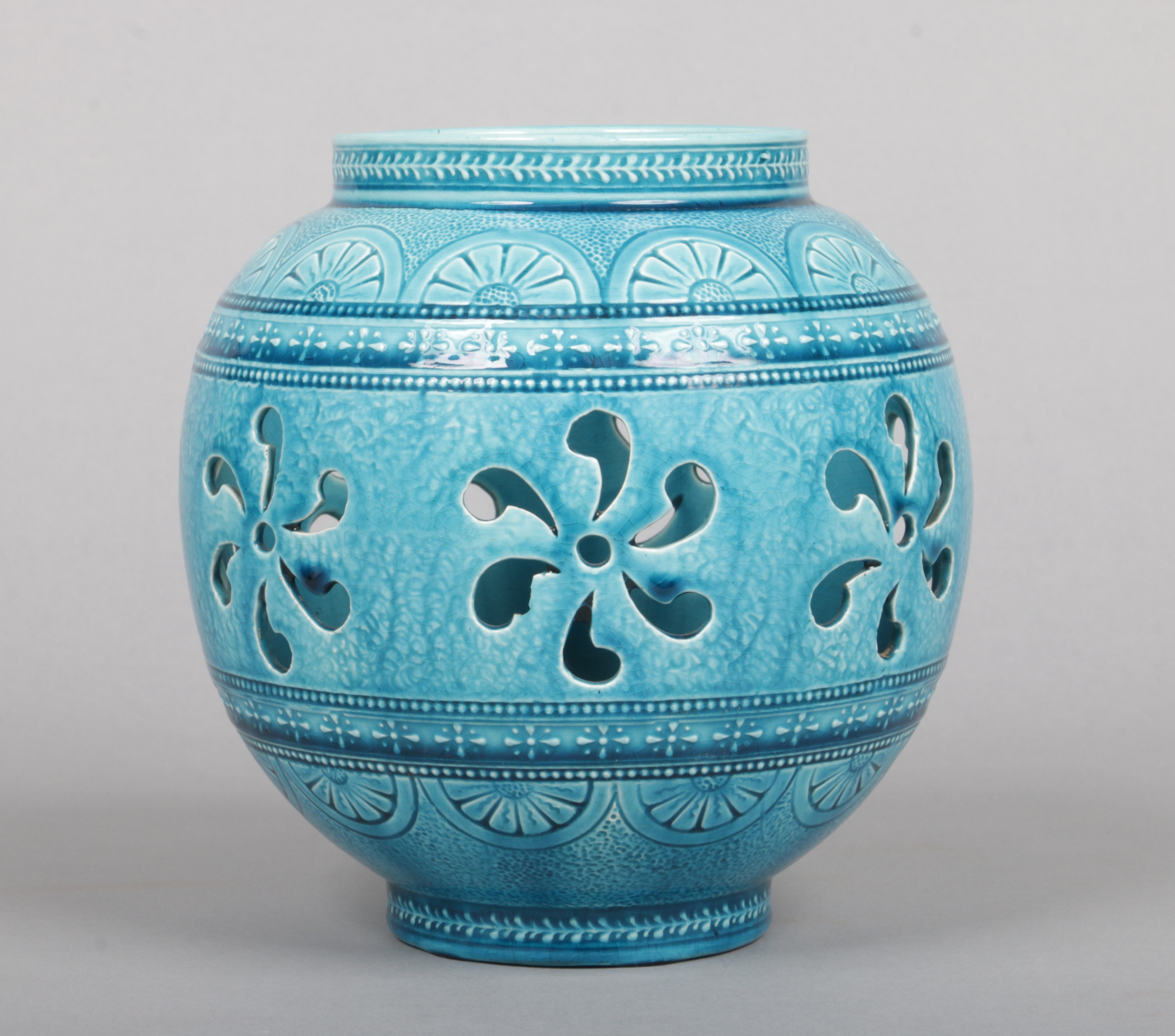 A Burmantofts Faience vase of ovoid form and decorated in Persian tastes. Pierced to the central