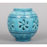 A Burmantofts Faience vase of ovoid form and decorated in Persian tastes. Pierced to the central