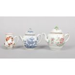 An 18th century Chinese famille rose teapot and cover along with a blue and white example and a