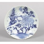 A 19th century Chinese provincial blue and white dish. Painted in underglaze blue with a phoenix and
