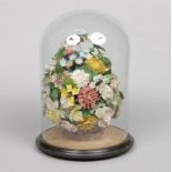 A shellwork flower bouquet in basket, raised on a marble plinth and under glass dome, 45cm. Glass