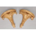 A pair of regency giltwood wall brackets of demi lue form and each carved with acanthus leaves, 30cm