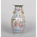 A 19th century Cantonese vase. Painted in coloured enamels with panels containing figures on a