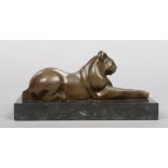 An Art Deco style bronze sculpture after Michel DeCoux. Formed as a recumbent wild cat on a slate