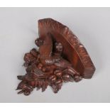 A Black Forest carved walnut wall bracket surmounted with a nesting bird, 24cm wide, 19cm high.