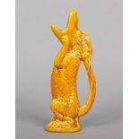 A Burmantofts Faience grotesque crocodile ewer glazed in yellow. Modelled in a seated pose with a