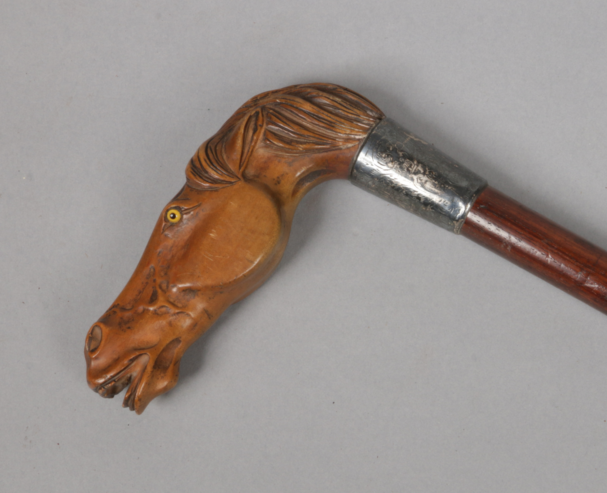 A George V walking stick with silver collar. The handle finely carved from boxwood in the form of