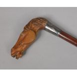A George V walking stick with silver collar. The handle finely carved from boxwood in the form of