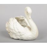 A Parian planter modelled in the form of a swan and with glass inset eyes, 28cm high.Condition