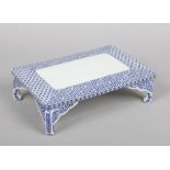 A Japanese porcelain rectangular blue and white stand. Painted in underglaze blue with fretwork