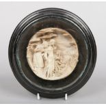A 19th century carved lava roundel plaque. Religious scene with Moses in a basket. Signed