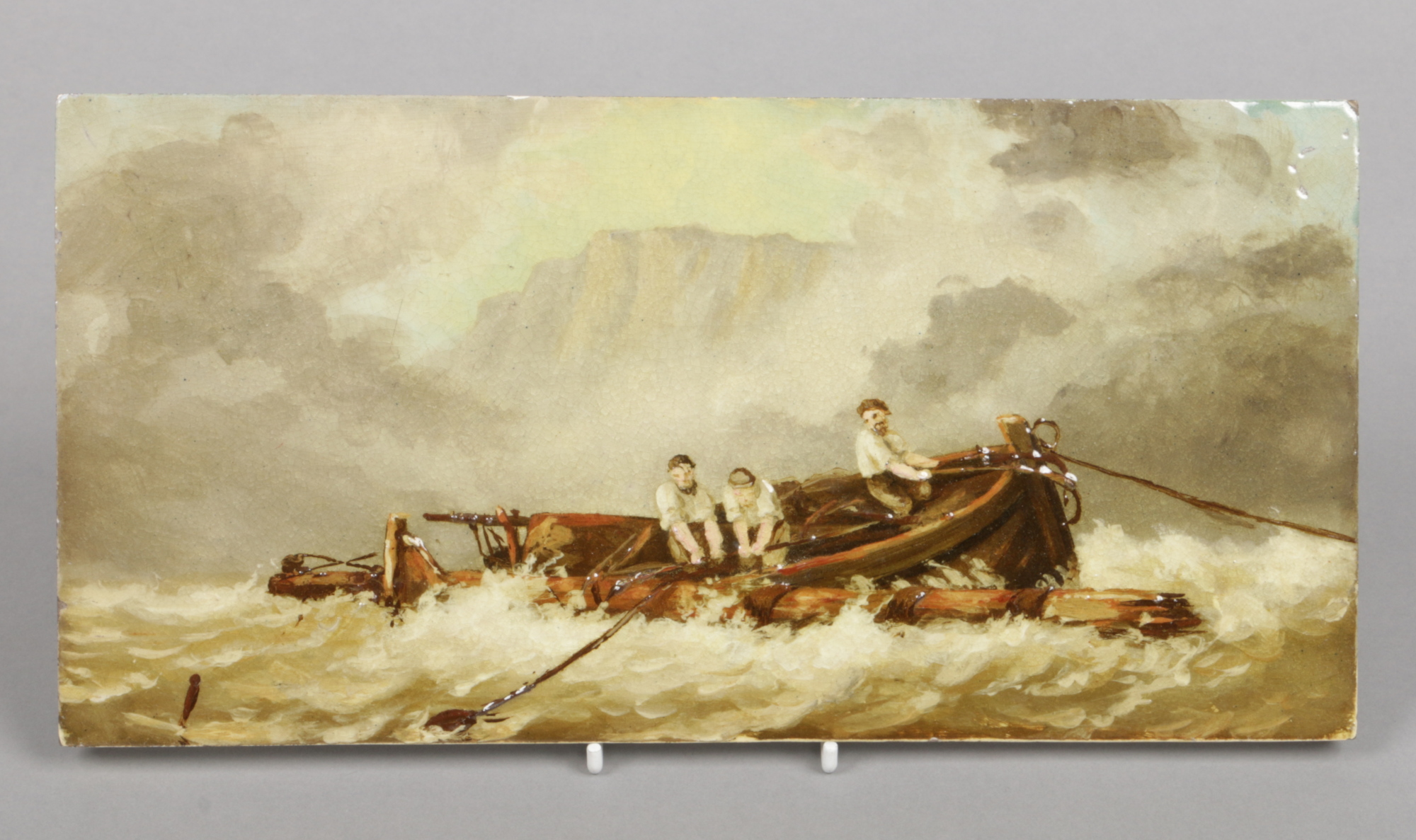 A Burmantofts tile painted with impasto enamel. Depicting a maritime scene with a shipwreck and