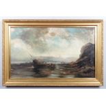 Frank Wasley (1854-1934). A large gilt framed oil on canvas, coastal scene with a grounded vessel
