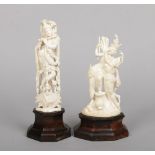 Two early 20th century Indian carved ivory figures of Hindu deities raised on hardwood plinths.