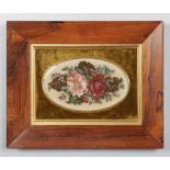 A 19th century needlework panel in rosewood frame and green velvet mount. Depicting a bouquet of