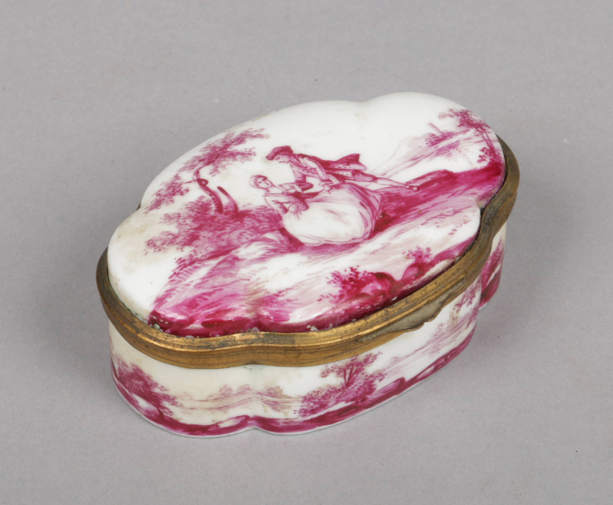 A 19th century Meissen style quatrefoil snuff box with hinged cover and gilt metal mount. Painted in