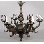 A Continental six branch cast bronze chandelier. Each scrolling branch with three sconces is