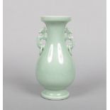 A 20th century Chinese celadon vase of archaistic form. With twin handles formed as mythical