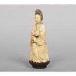 A Japanese Meiji period ivory okimono. Formed as a Bijin holding a scroll and a fan. With incised