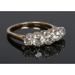 An 18 carat gold five stone diamond ring. Set with old cut diamonds of graduating size, the