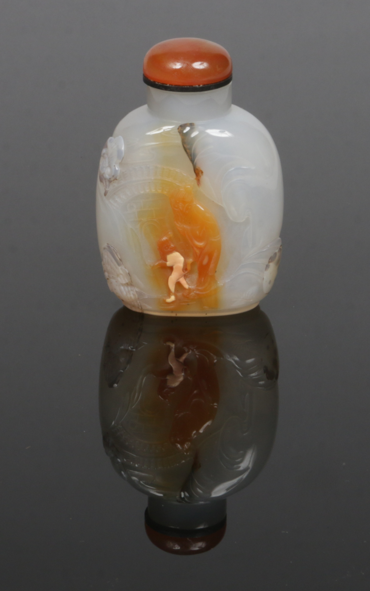 A 19th century Chinese well hollowed agate snuff bottle. Carved in low relief to depict a sage and a