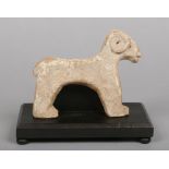 An antique primitive eastern terracotta model of a ram on associated stand, 15cm.