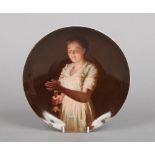 An early 20th century Vienna dish. Painted with the portrait of a girl holding a candle. Titled Good
