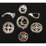 Seven Scottish silver and white metal brooches including hardstone set examples.