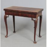 A George II Irish mahogany fold over tea table. Raised on cabriole supports carved with shell