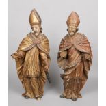 Two 17th century carved polychrome and giltwood figures of Bishops, 80cm.