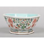 A Chinese famille verte octagonal bowl. With turquoise interior and painted with peaches, fruit bats