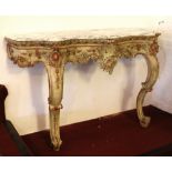 A 19th century French carved and painted marble top console table of serpentine form and raised on