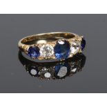 An 18 carat gold, sapphire and diamond ring set with old cut stones. With three sapphires