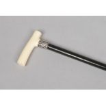 A ladies Victorian ebonized walking cane with silver collar and carved ivory grip. Total weight